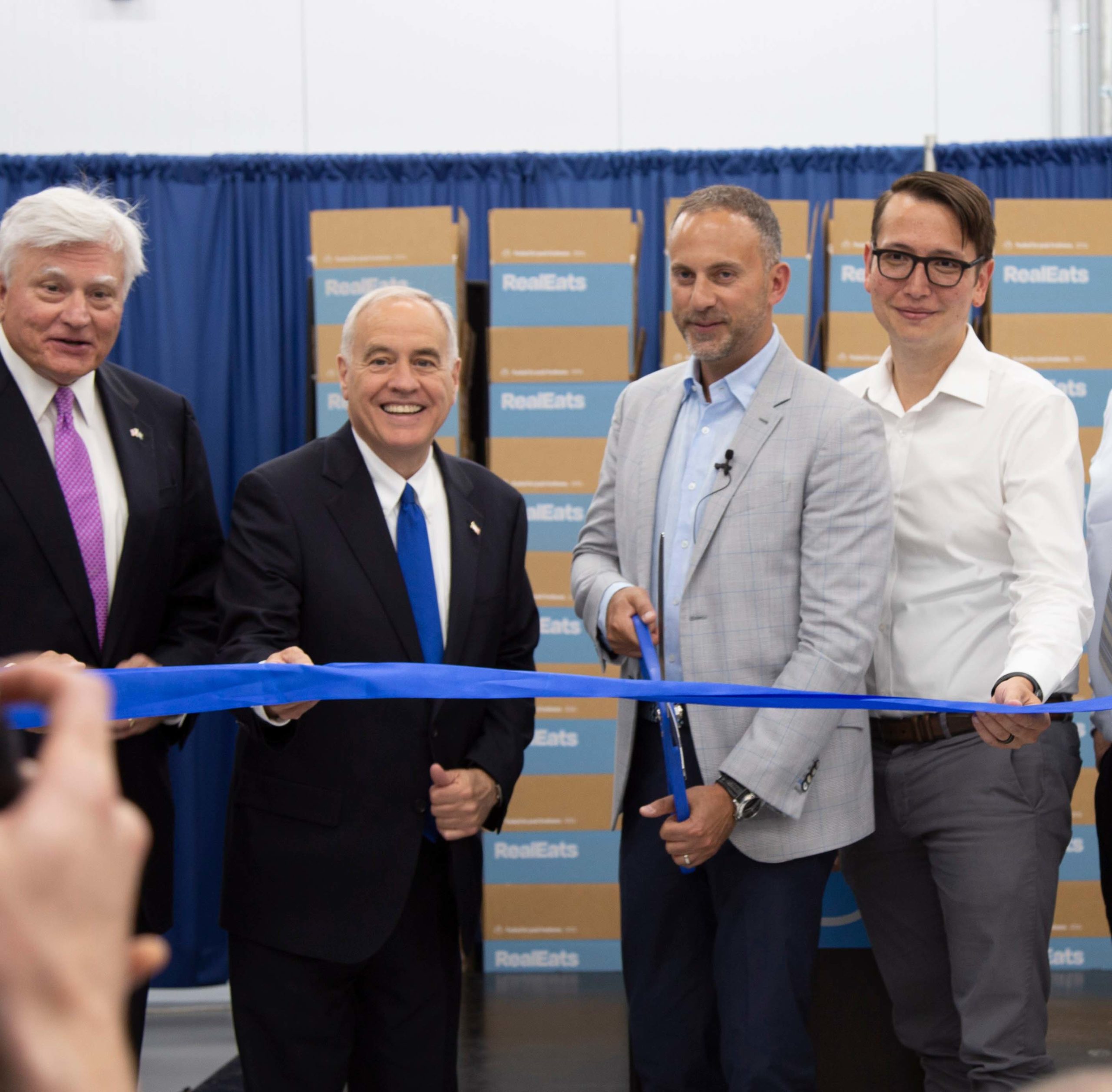 Mike Nizzolio, Tom DiNapoli, Dan Wise and Eric from the RealEats team cut a ceremonial ribbon
